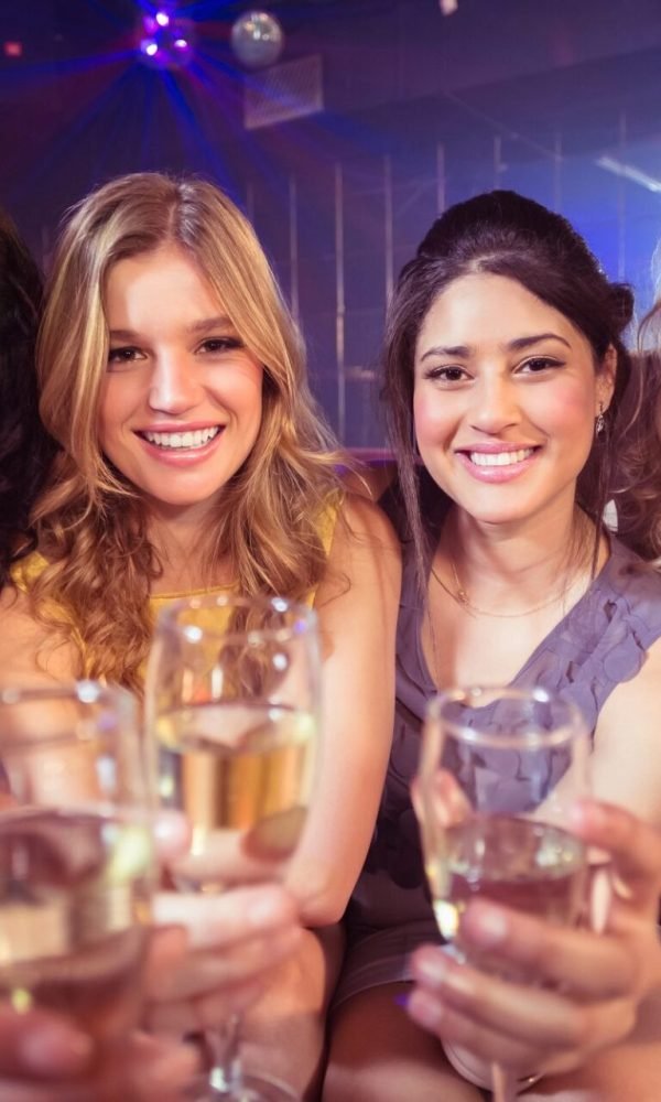 Four friends toasting drinks at a bachelorette party in Palm Springs
