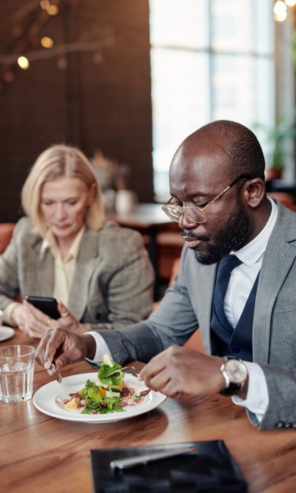 Businessman eating a plated salad at a corporate business lunch in Palm Springs